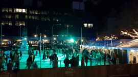 Crowds Skating on Festive Ice Rink