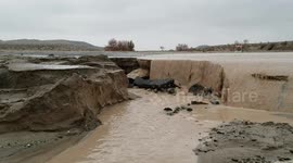 Highway in Southern California desert washing out in the rain