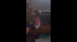 Vivian climbing on the TV stand