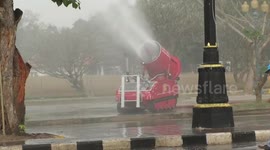 Thai authorities deploy water barrels to battle smog pollution in the streets