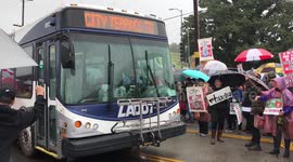 Day 3 of the Los Angeles Teachers Strike. A police squad car escorts a city bus trapped within a closed off street due to the educator protest.