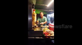 A street vendor selling chicken kabab.