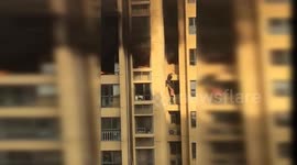 Two residents forced to jump to lower floor to escape high-rise fire