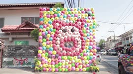 Impressive mural of a pig made from hand-painted umbrellas