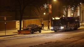 Snowstorm Hits Albany: Bus and Snowplow drive on snowy street