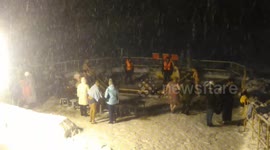 Swimming in the iced lake during snowfall