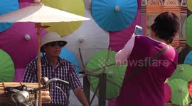 Tourists enjoy colourful umbrella festival in northern Thailand