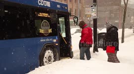 Northeast snowstorm: Passengers board bus in driving snow in downtown Albany