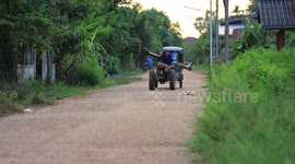Life in rural Thailand, a farmer transports a water pump to his rice field.