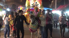 Thai children struggle to ride ponies at festival