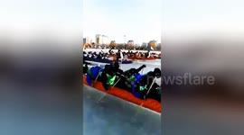 Dragon boat race held on frozen river using ice picks instead of paddles
