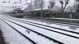 Paris sub-urban train under snow .