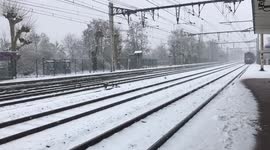 Paris Sub Urban train arring under snow in station .