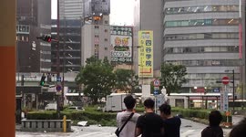Locals in Osaka run for cover from flying debris during Typhoon Jebi