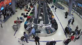 UNEDITED: German thief, 39, caught on CCTV stealing British woman's suitcase from airport baggage carousel