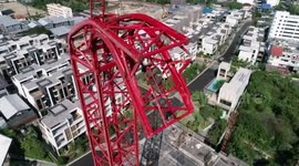 Thai builder left hanging 200ft in the air after crane collapses