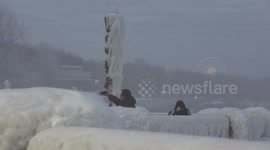 Niagara falls tourist area covered in thick ice and frozen over in severe cold weather in Canada