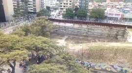 Protesters run from Venezuelan police during day of protest against Nicolás Maduro