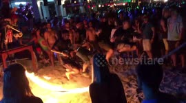 Daring revellers are hit with flaming jump rope during Full Moon Party in Koh Phangan