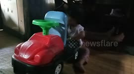 Little girl pops open the hood to check her toy car is working