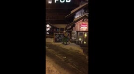 Drunk Fool Trying To Put His Skis On After One Too Many Falls Over