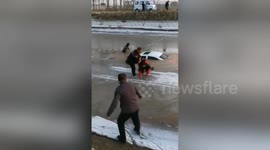 Villagers save man trapped in car that fell into icy river