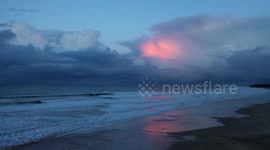 Drone Flight Along Beach With Twilight Storm Clouds