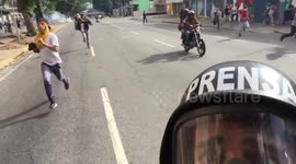 VENEZUELA CRISIS: Journalist films moment he fled riot police on motorbike