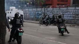 Police officers clash with civilians in Caracas