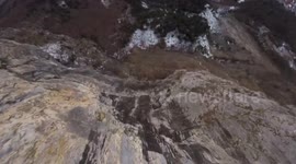 Man does dizzying triple somersault off a cliff during base jump