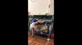 The littel boy tried to climb into the crib to sleep