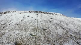 Drone flight over mountain snow in Northern Ireland