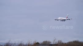 emirates a380 battles stormy weather and crosswinds to land at manchester airport