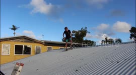 kid skateboards off his roof onto a trampoline