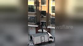 Heroic man catches baby dropped by mother trying to flee burning building
