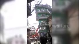 Bumbling crane driver tries to pull down three-storey building, structure comes crashing on him