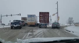 Pair of 18-wheelers stuck on icy Colorado road have to be partially dug out