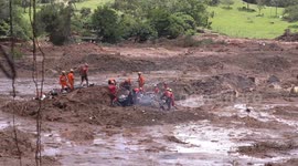 Brazil dam collapse: rescue crews saw through debris