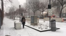 NYC: Pedestrian walks through falling snow in Lower Manhattan