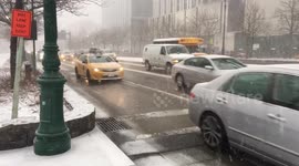NYC traffic moves through snowstorm