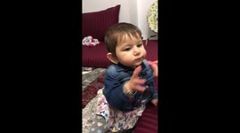 Baby eating sour gummies first time