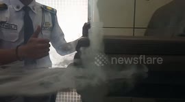 Man makes smoke vortex out of exhaled smoke on table