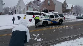 Friendly police join in snowball fight with neighbourhood kids