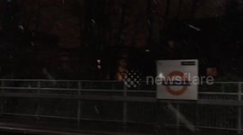 Snow falls in hackney station