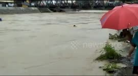 People Rescue A Floated Man From The Flooded River in Indonesia