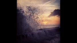 Beautiful slow-motion crashing waves at sunset