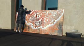 Polish street artist causes a splash with colourful lace-pattern murals