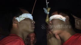 Two blindfolded men tried to eat a chicken leg