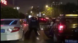 Suspected robber crashes through traffic during police chase in China