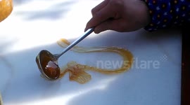 Street vendor makes dragon-shaped sweet with maltose syrup